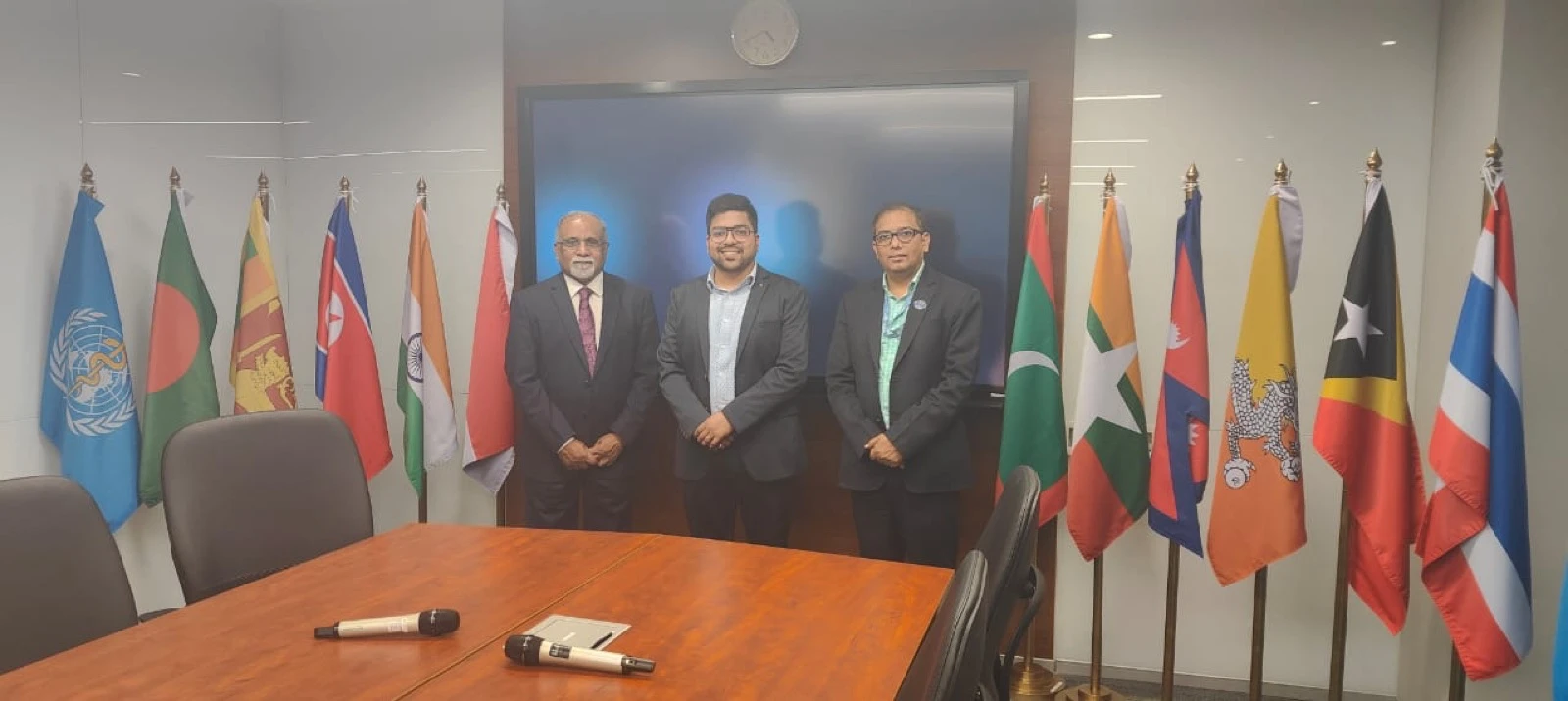Clinics On Cloud leadership at an international meeting, member-nation flags behind them