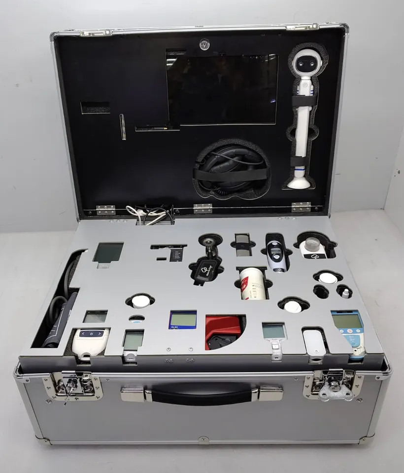 Open Box Clinic case showing diagnostic devices arranged in foam slots with tablet and examination camera in the lid