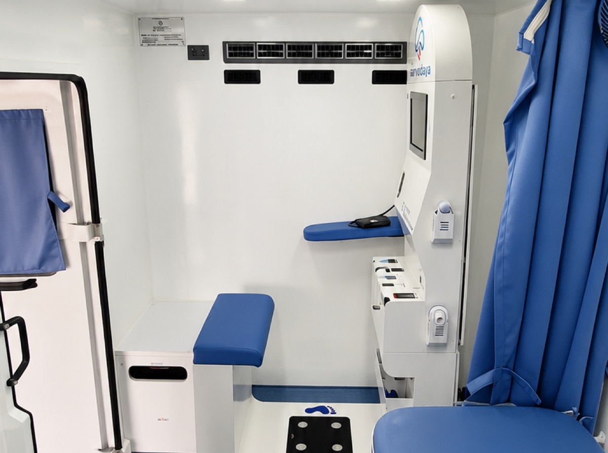 Examination area with foldable table and cushioned patient bed